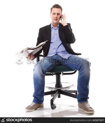 Full length businessman reads newspaper phoning talking on mobile phone commenting economy news isolated on white background