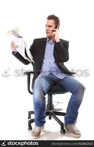 Full length businessman reads newspaper phoning talking on mobile phone commenting economy news isolated on white background