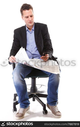 Full length businessman reads newspaper phoning talking on mobile phone commenting economy news isolated on white background