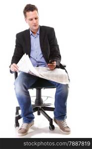 Full length businessman reads newspaper phoning talking on mobile phone commenting economy news isolated on white background