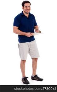 Full length image of a handsome young guy standing isolated against white background