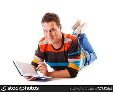 Full length male student lying on floor reading a book preparing for exam isolated on white background