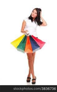 Full length of a happy young lady holding shopping bags against isolated white background