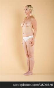 Full length of a woman standing topless
