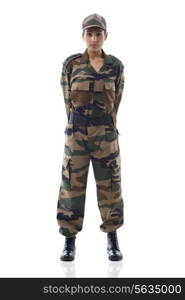 Full length of a young female soldier standing against white background