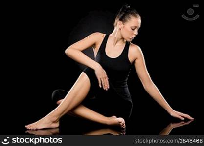 Full length of an attractive woman in spine twisting pose