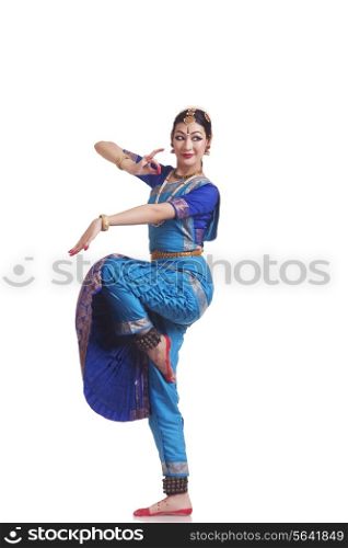 Full length of beautiful Bharatanatyam dancer performing on white background