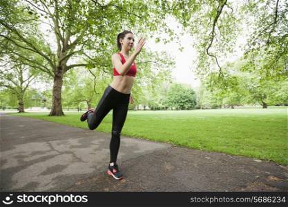 Full length of beautiful fit woman jogging in park