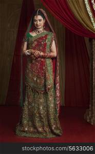 Full length of beautiful young bride standing