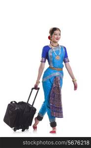 Full length of Bharatanatyam dancer with luggage against white background