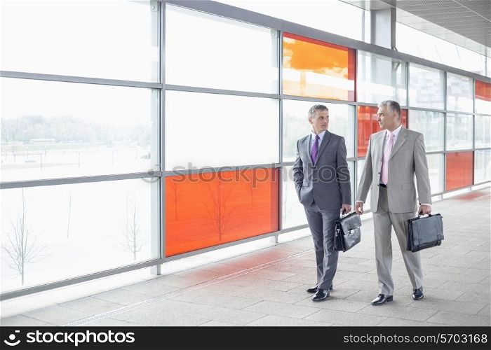 Full length of businessmen with briefcase walking in railroad station
