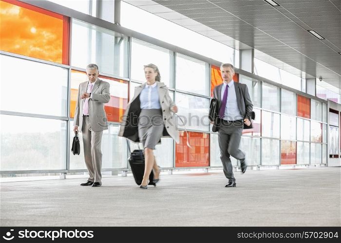Full length of businesspeople rushing in railroad station