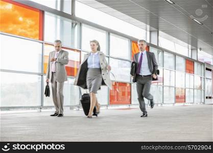 Full length of businesspeople rushing in railroad station