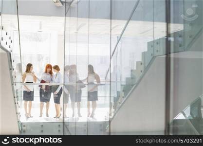 Full-length of businesswomen conversing in office
