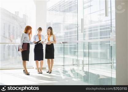 Full-length of businesswomen discussing in office