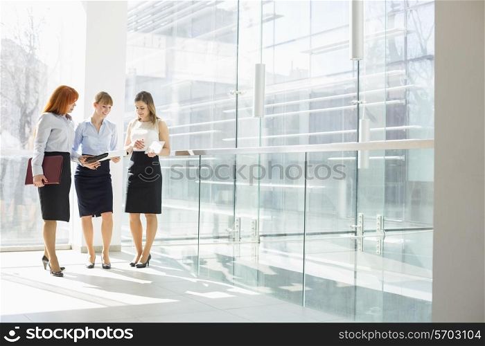 Full-length of businesswomen doing paperwork in office