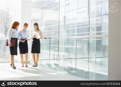 Full-length of businesswomen doing paperwork in office