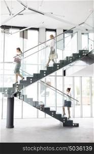 Full length of businesswomen on staircase at new office