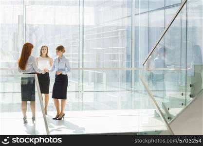 Full-length of businesswomen shaking hands in office
