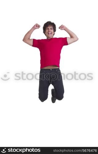 Full length of cheerful young man with clenched fists over white background