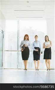 Full-length of confident businesswomen standing in office