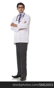 Full length of confident doctor standing over white background