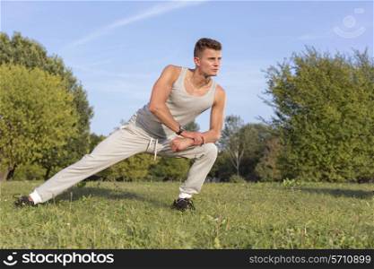 Full length of confident man exercising in park