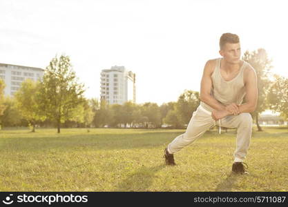 Full length of confident young man exercising in park