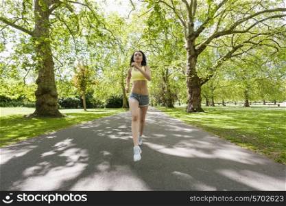 Full length of determined fit woman jogging at park