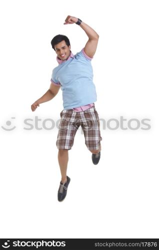 Full length of excited young man jumping over white background