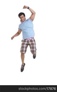 Full length of excited young man jumping over white background