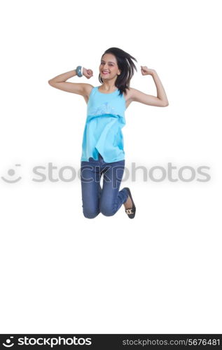 Full length of excited young woman jumping isolated over white background