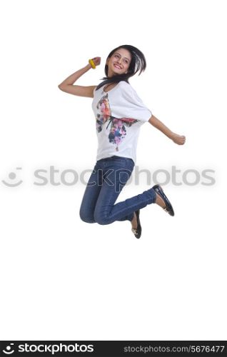 Full length of excited young woman jumping over white background