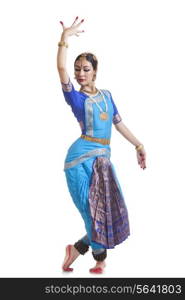 Full length of female Bharata Natyam performer over white background