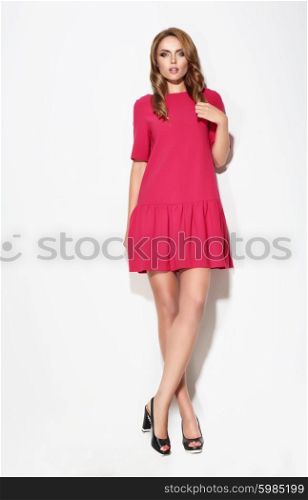 Full length of female in pink dress posing. Fashion.