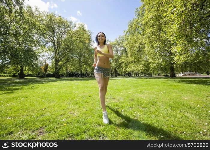 Full length of fit woman jogging at park