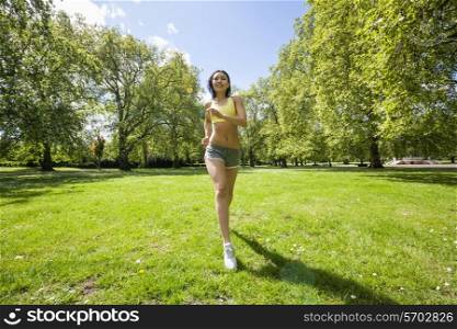 Full length of fit woman jogging at park