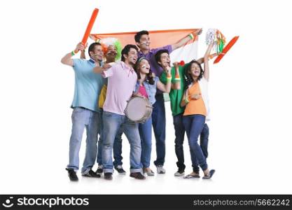 Full length of happy young friends looking away while cheering with Indian flag over white background