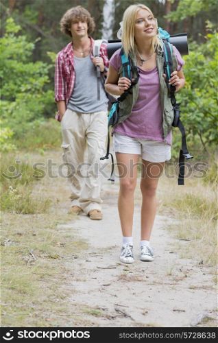 Full length of hiking couple in forest