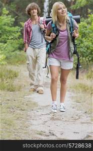 Full length of hiking couple in forest