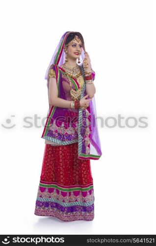 Full length of Indian bride standing against white background