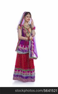 Full length of Indian bride standing against white background