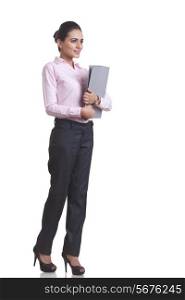 Full length of Indian businesswoman holding file folder over white background