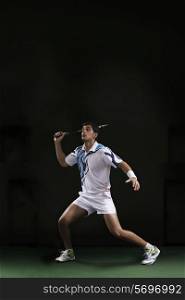 Full length of man playing badminton at court
