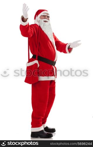 Full length of Santa Claus greeting u over white background