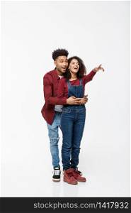 full length of smiling African American boyfriend and girlfriend pointing away isolated on white background. full length of smiling African American boyfriend and girlfriend pointing away isolated on white background.
