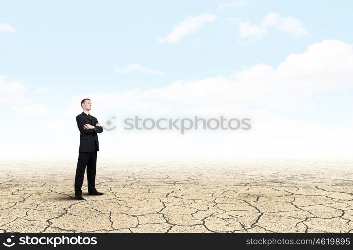 Full length of thoughtful businessman looking away. Pensive businessman