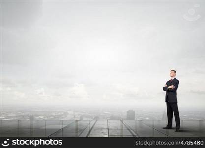 Full length of thoughtful businessman looking away. Pensive businessman