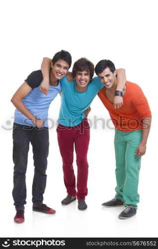 Full length of three male friends smiling together over white background