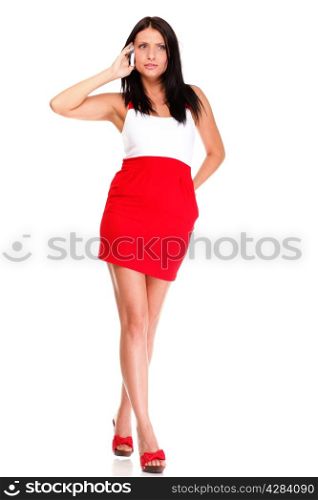 Full length of woman walking talking on mobile phone isolated on white background